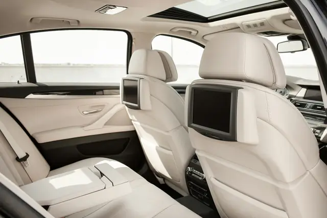 Spotless cream leather rear seats of a luxury car