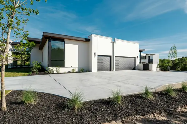 Clean concrete driveway in front of a modern home