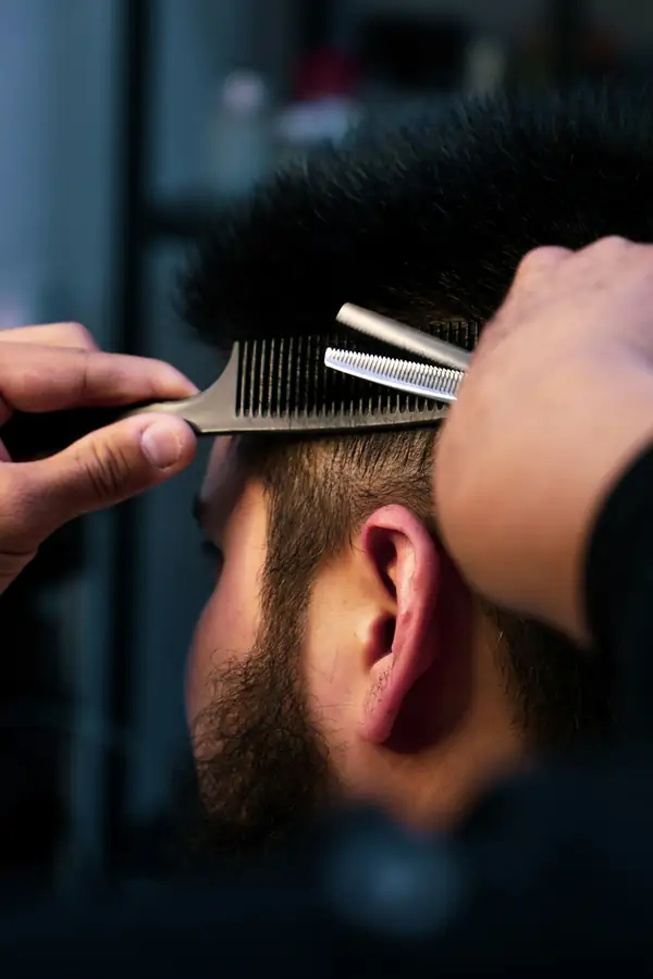 Close-up of a comb and thinning shears at work