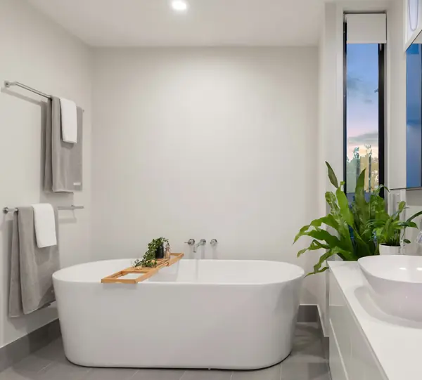 Bright bathroom with a freestanding white tub and vessel sink