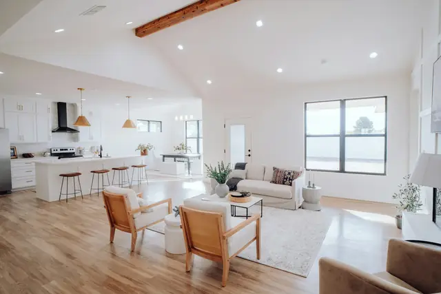 Open-plan living room and kitchen with light wood floors