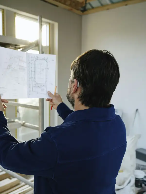 Project lead reviewing floor plans on a job site
